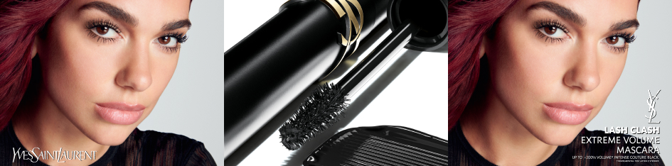 Werbebild für YSL Lash Clash Mascara: Nahaufnahmen einer Frau mit langen, voluminösen Wimpern und rotbraunem Haar links und rechts im Bild. In der Mitte eine Großaufnahme einer schwarzen Mascara-Bürste mit goldenen Details. Rechts Text: 'Lash Clash Extreme Volume Mascara – Up to +200% Volume – Intense Couture Black' mit YSL-Logo.