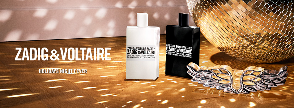 Werbebanner mit den Düften This Is Him! und This Is Her! von Zadig & Voltaire. Schwarzer und weißer Flakon stehen nebeneinander auf goldenem Boden mit Lichteffekten, daneben ein silbernes Flügelornament und eine Diskokugel. Text: „Zadig & Voltaire – Holidays Night Fever“.